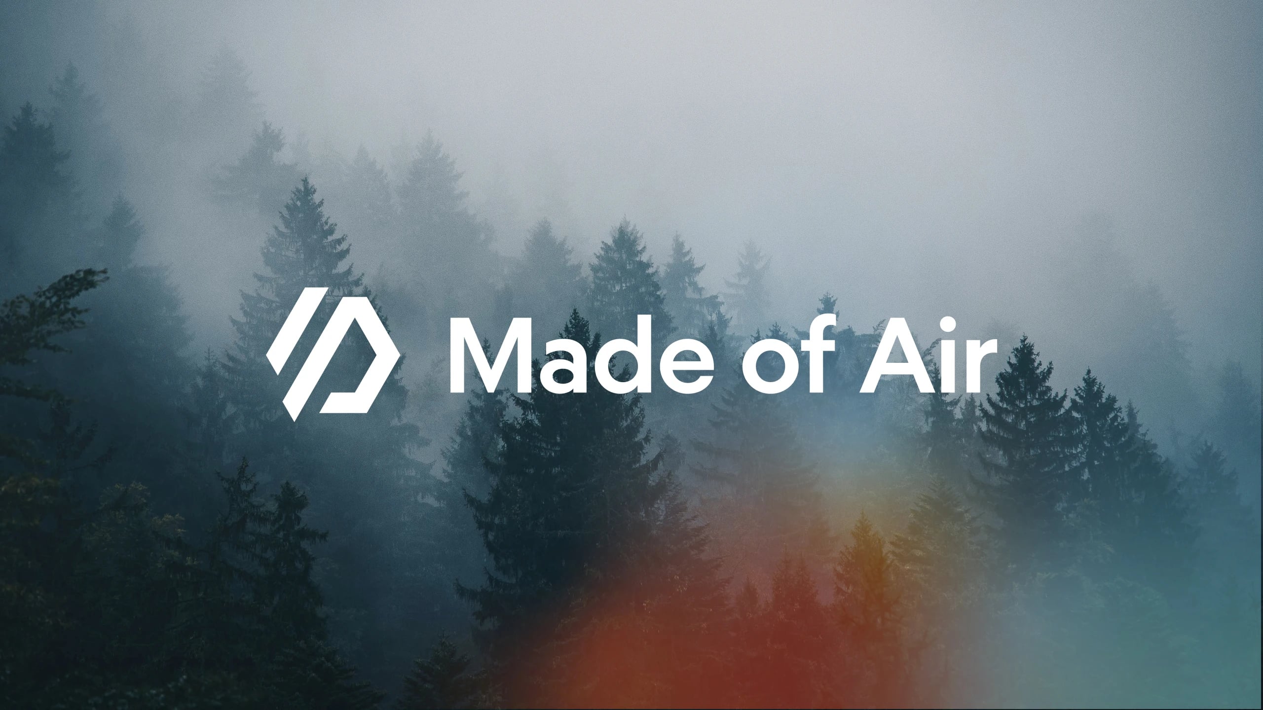 The Made of Air logotype in white over a photograph of fog-covered conifer forest, an orange glow rising at the lower edge