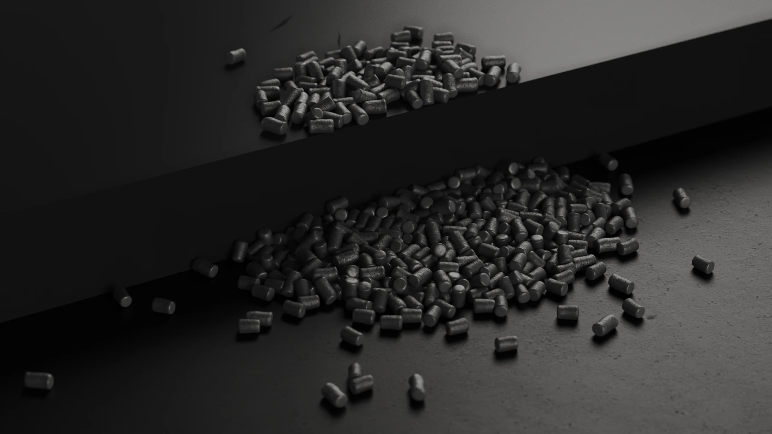 Rendered pile of black carbon granules spilling across a surface in raking light